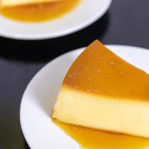 Creamy caramel flan served on white plates, perfect for dessert lovers.